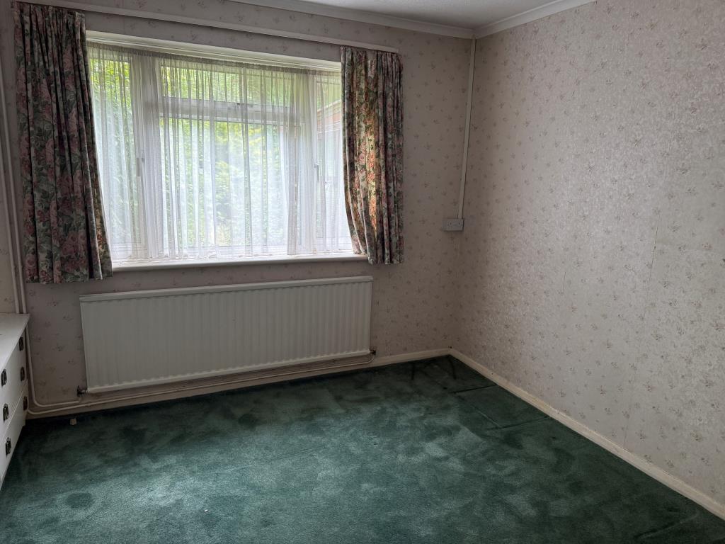 Lot: 159 - BUNGALOW WITH GARAGE AND GARDENS IN NEED OF MODERNISATION - Main bedroom with window to rear
